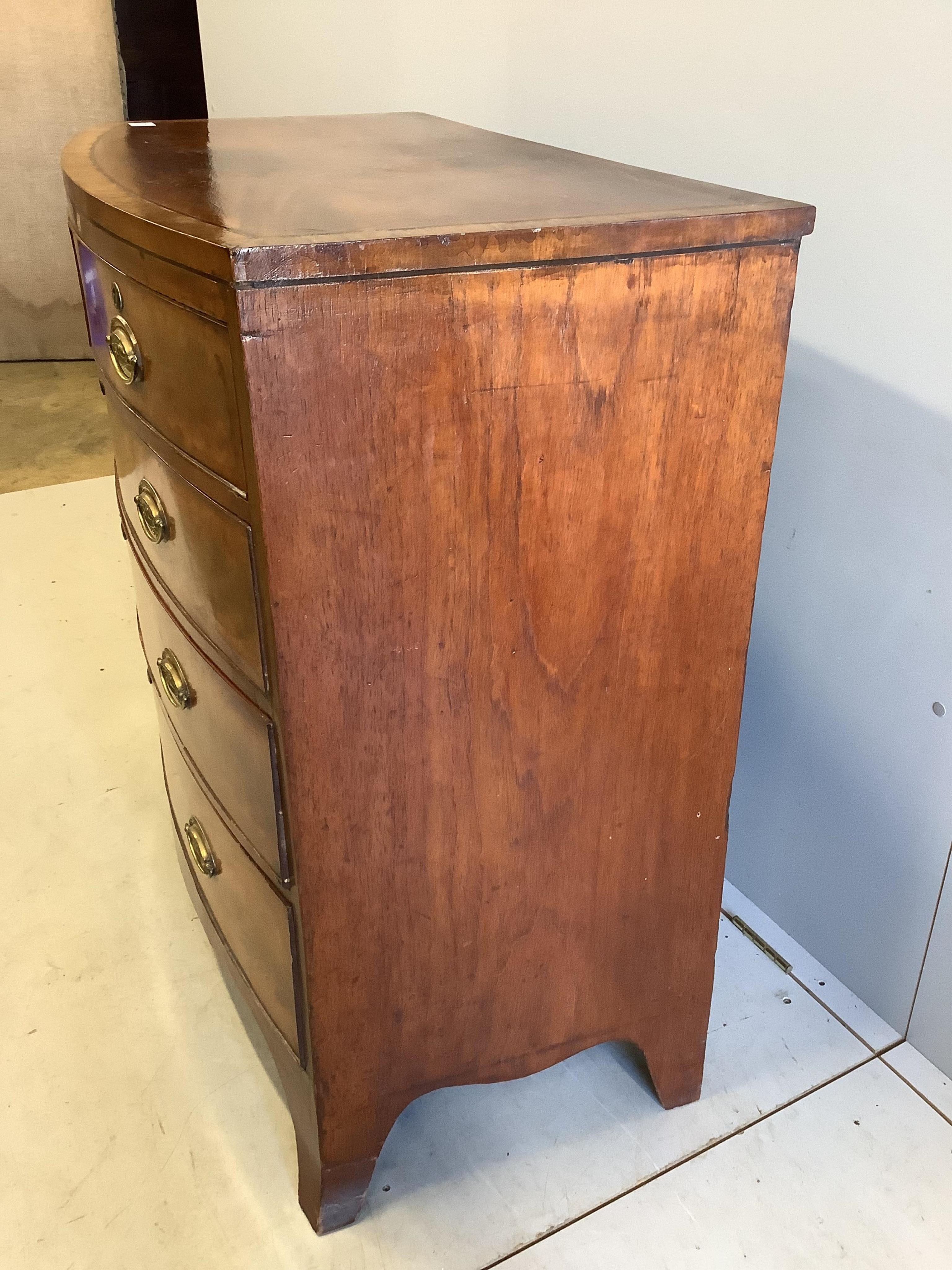 A Regency banded mahogany bowfronted chest, fitted two short and three long drawers, with oval stamped brass handles, width 103cm, depth 54cm, height 97cm. Condition - poor to fair